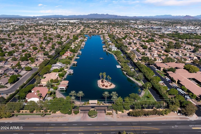 drone / aerial view featuring a water and mountain view