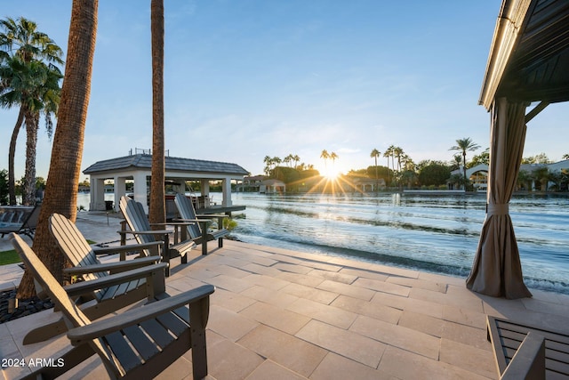 view of patio / terrace with a gazebo and a water view