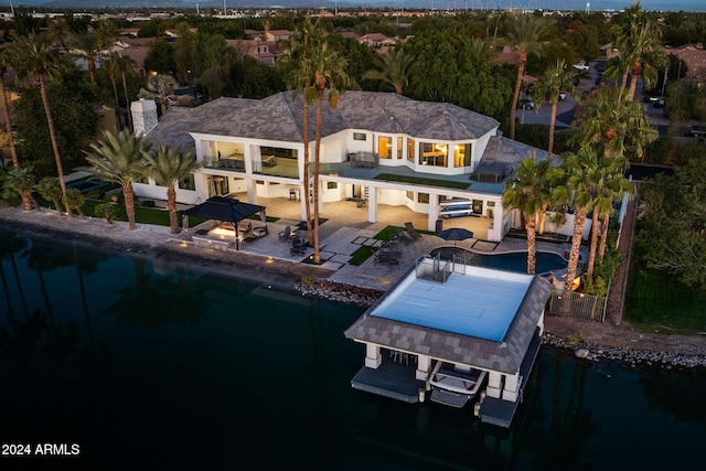 rear view of property featuring a water view and a patio