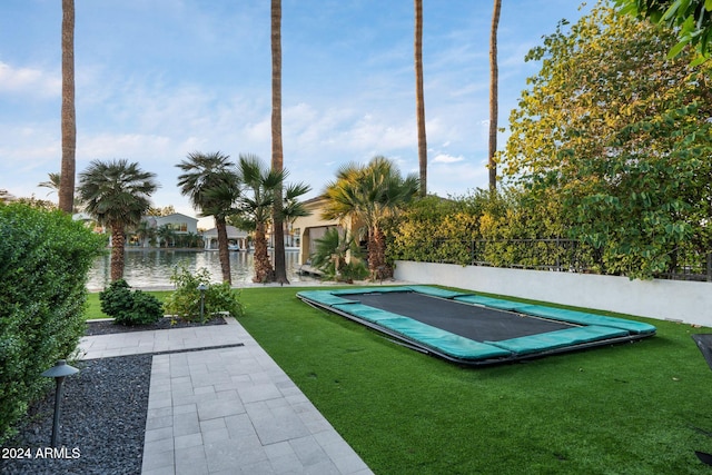 view of swimming pool with a yard and a trampoline