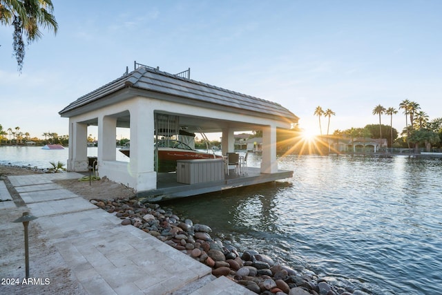 view of dock with a gazebo and a water view