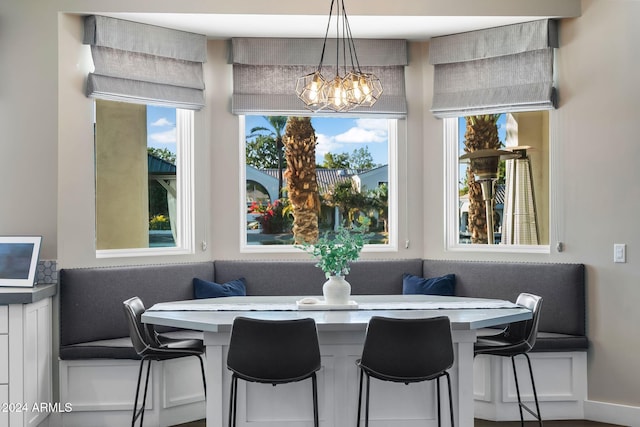 dining space with breakfast area, a wealth of natural light, and an inviting chandelier