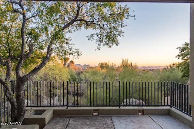 view of balcony at dusk