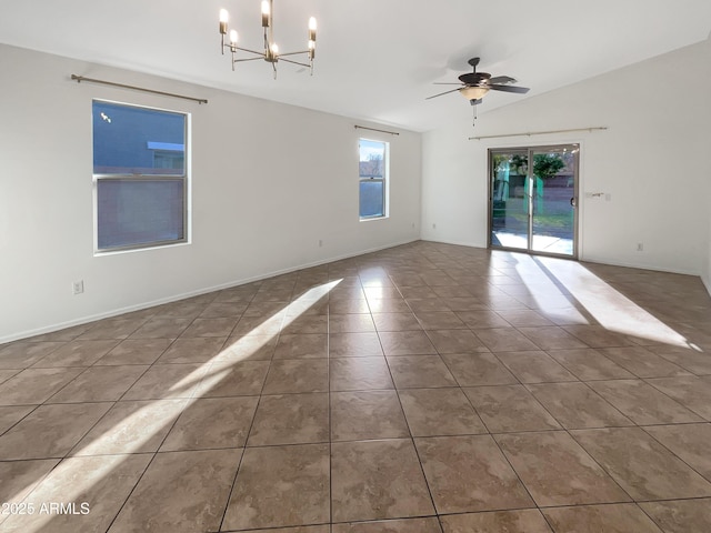 empty room featuring tile patterned floors, ceiling fan with notable chandelier, and lofted ceiling