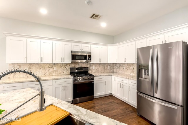 1492 E Westchester Dr, Chandler, AZ 85249 - kitchen featuring stainless steel appliances, white cabinets, and tasteful backsplash