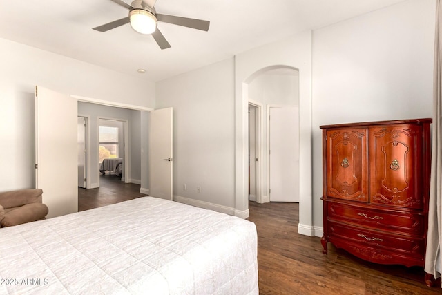 1492 E Westchester Dr, Chandler, AZ 85249 - bedroom with arched walkways, dark wood-style flooring, baseboards, and a ceiling fan