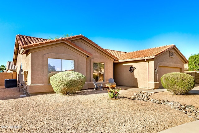 1492 E Westchester Dr, Chandler, AZ 85249 - mediterranean / spanish-style home with a tiled roof, stucco siding, a garage, and central air condition unit