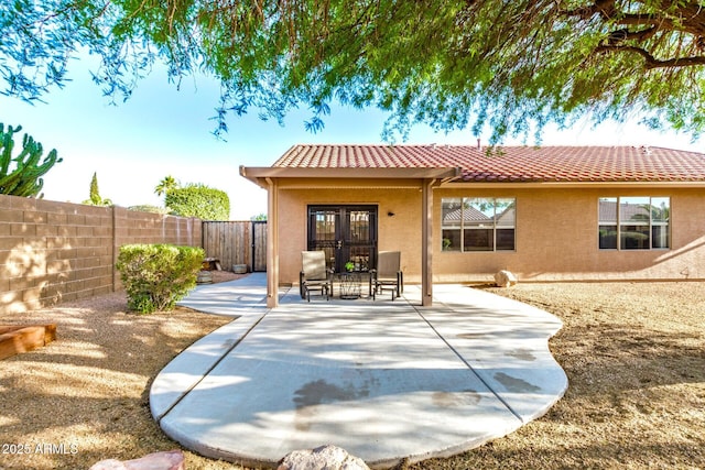 1492 E Westchester Dr, Chandler, AZ 85249 - back of property with a tile roof, french doors, a fenced backyard, stucco siding, and a patio