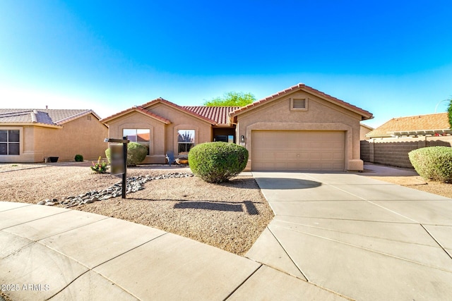 1492 E Westchester Dr, Chandler, AZ 85249 - view of front of home with a tiled roof, concrete driveway, a garage, fence, and stucco siding