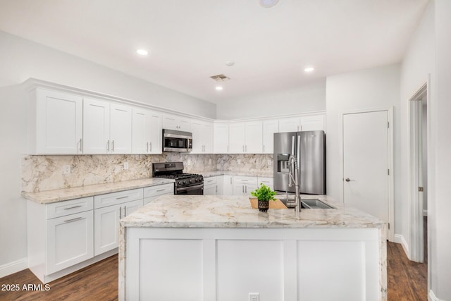 1492 E Westchester Dr, Chandler, AZ 85249 - kitchen with appliances with stainless steel finishes, white cabinetry, decorative backsplash, dark wood-type flooring, and recessed lighting