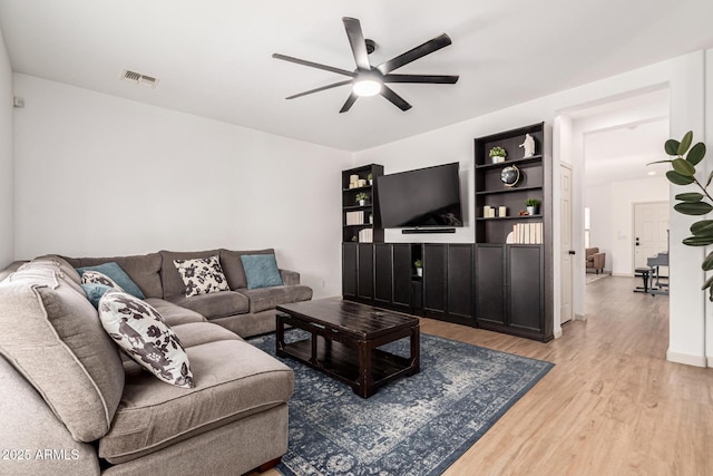 living room with ceiling fan and light hardwood / wood-style flooring