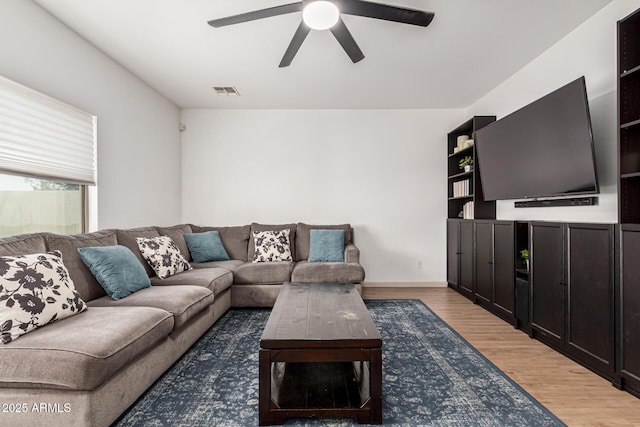 living room with ceiling fan and wood-type flooring