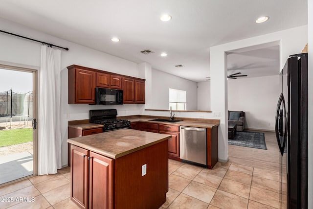 kitchen featuring sink, light tile patterned floors, ceiling fan, black appliances, and a kitchen island