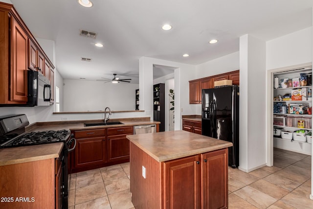 kitchen featuring light tile patterned flooring, sink, a kitchen island, ceiling fan, and black appliances