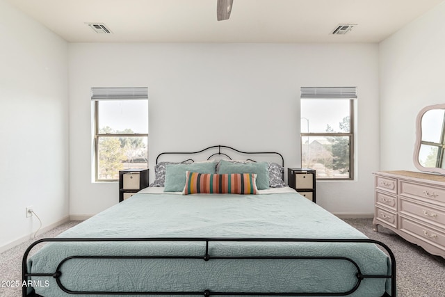 bedroom featuring multiple windows, ceiling fan, and carpet flooring