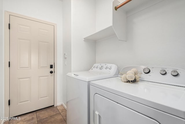 laundry room featuring light tile patterned floors and washing machine and dryer