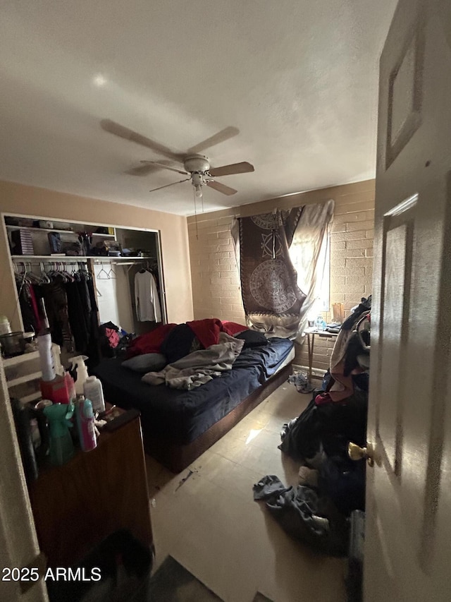 bedroom featuring ceiling fan and a closet