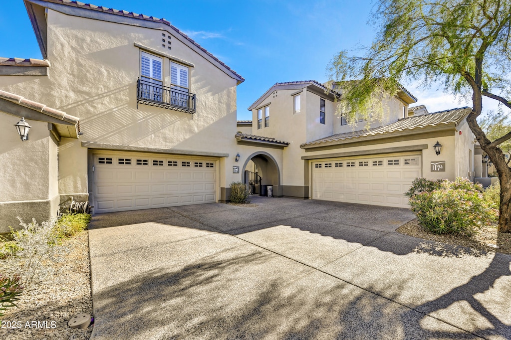 mediterranean / spanish home featuring a garage