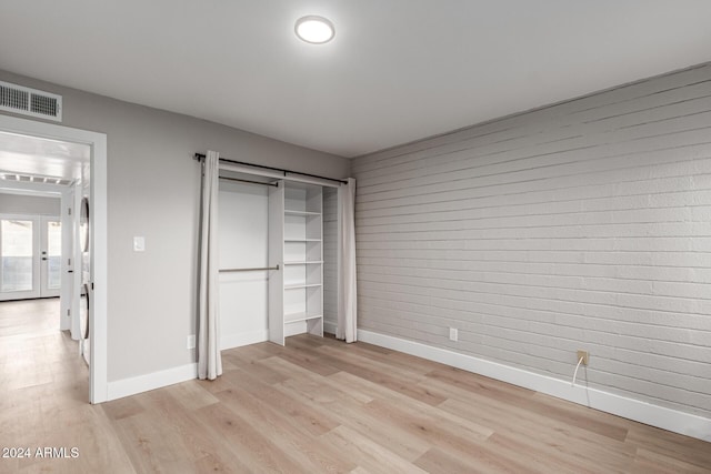 unfurnished bedroom featuring light wood-style floors, visible vents, and baseboards