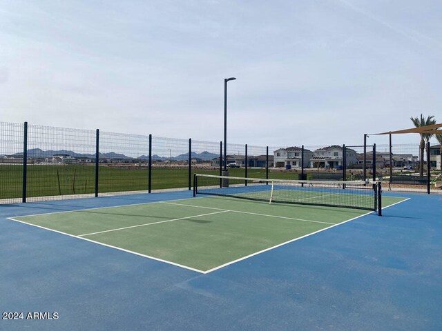 view of sport court with basketball hoop