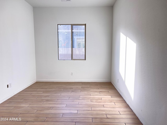 unfurnished room featuring light hardwood / wood-style floors