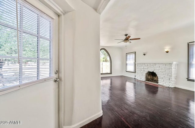 3949 E Earll Dr, Phoenix, AZ 85018 - unfurnished living room with baseboards, ceiling fan, wood finished floors, and a fireplace
