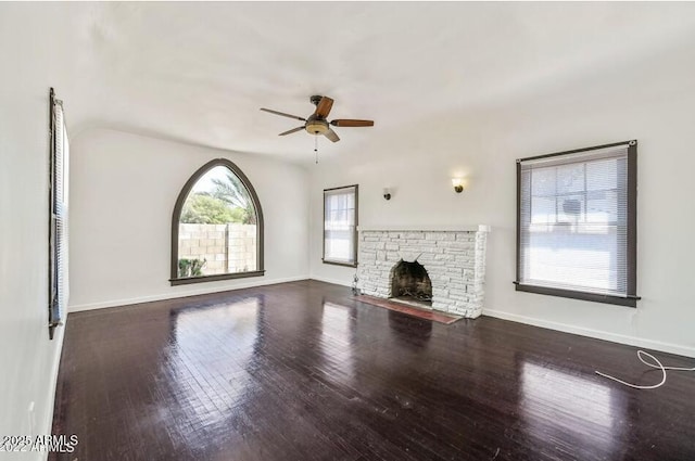 3949 E Earll Dr, Phoenix, AZ 85018 - unfurnished living room featuring ceiling fan, wood finished floors, a stone fireplace, and baseboards