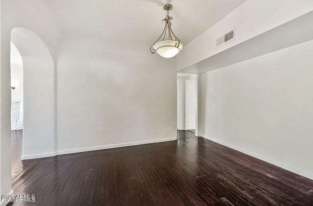 3949 E Earll Dr, Phoenix, AZ 85018 - spare room featuring arched walkways, wood finished floors, and baseboards
