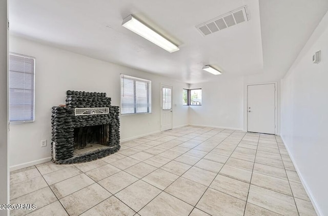 3949 E Earll Dr, Phoenix, AZ 85018 - unfurnished living room with light tile patterned floors, a fireplace, and baseboards