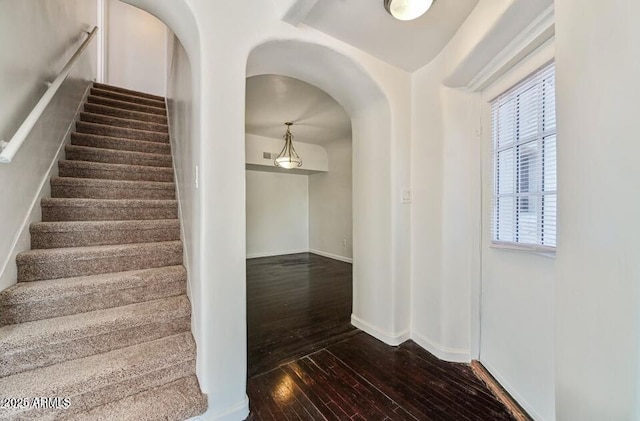 3949 E Earll Dr, Phoenix, AZ 85018 - staircase featuring hardwood / wood-style flooring, arched walkways, and baseboards