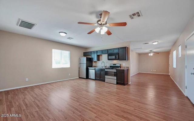 3949 E Earll Dr, Phoenix, AZ 85018 - kitchen with stainless steel appliances, ceiling fan, open floor plan, and healthy amount of natural light