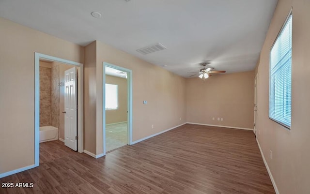 3949 E Earll Dr, Phoenix, AZ 85018 - spare room with a ceiling fan, plenty of natural light, wood finished floors, and baseboards