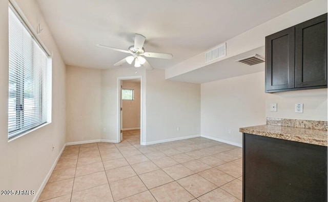 3949 E Earll Dr, Phoenix, AZ 85018 - spare room with a ceiling fan, baseboards, and light tile patterned floors