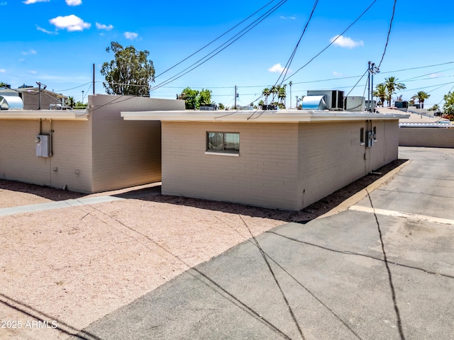3949 E Earll Dr, Phoenix, AZ 85018 - view of side of property featuring brick siding and a patio area