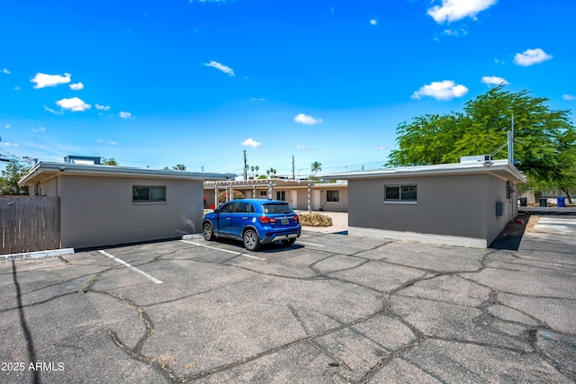3949 E Earll Dr, Phoenix, AZ 85018 - rear view of property with uncovered parking, brick siding, and concrete block siding