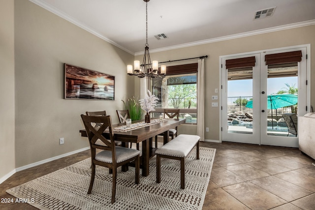 dining area with french doors, an inviting chandelier, tile patterned floors, and crown molding