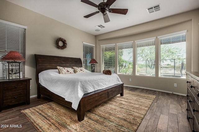 bedroom with ceiling fan and dark hardwood / wood-style flooring