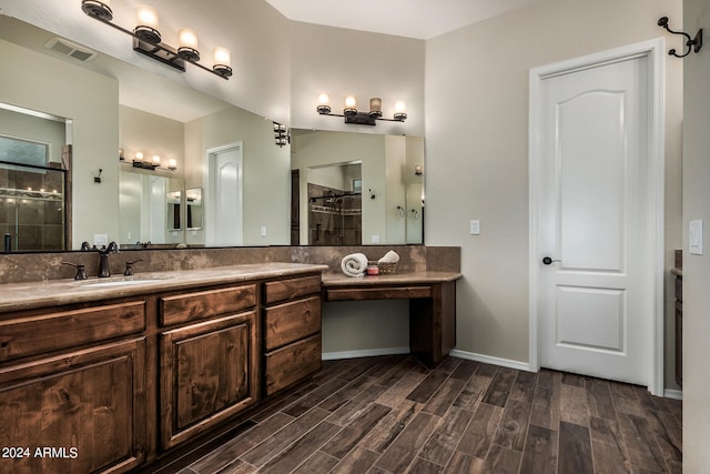 bathroom featuring an enclosed shower and vanity