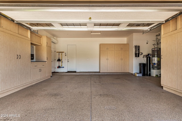 garage featuring gas water heater and an AC wall unit