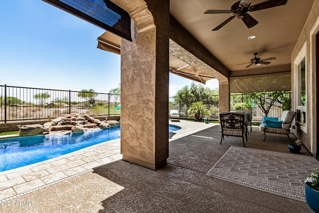 view of patio featuring pool water feature, ceiling fan, and a fenced in pool