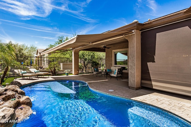 view of pool featuring ceiling fan and a patio area