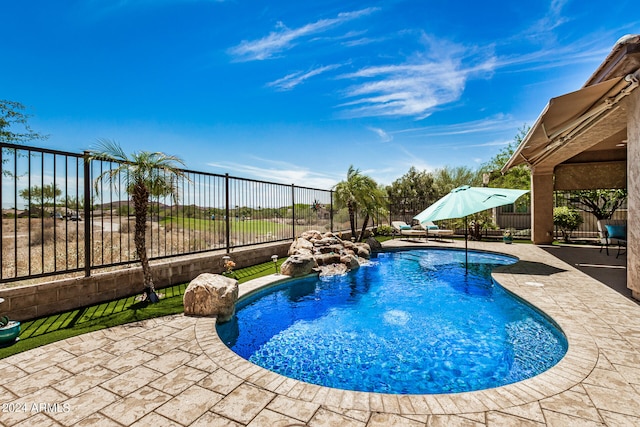 view of pool featuring pool water feature and a patio area