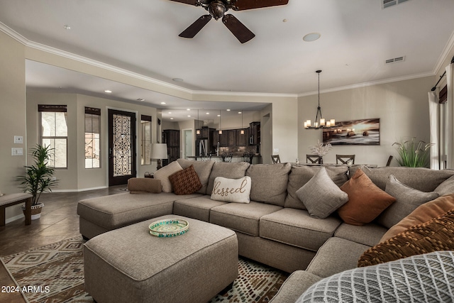 tiled living room featuring crown molding and ceiling fan with notable chandelier