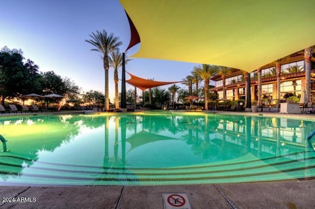 view of pool at dusk