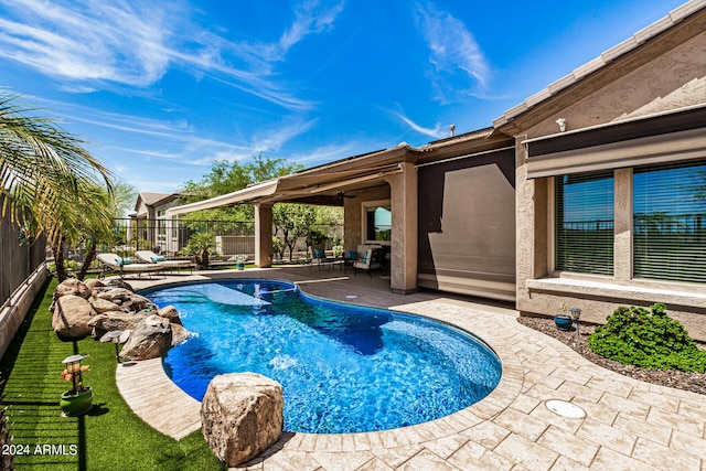 view of pool with ceiling fan and a patio area