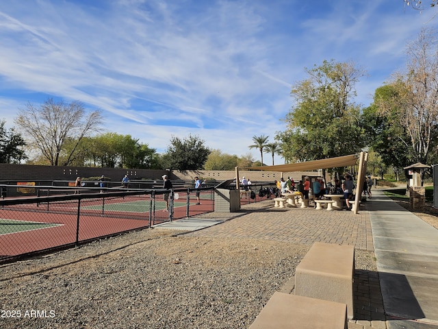 view of property's community featuring tennis court