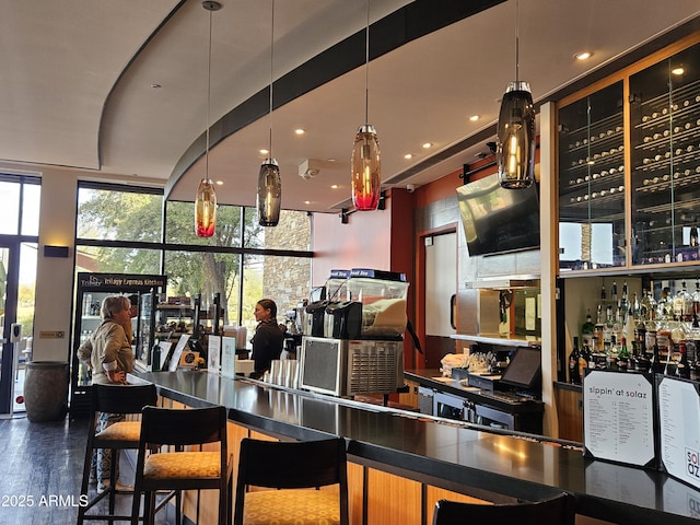 bar featuring floor to ceiling windows and dark hardwood / wood-style floors