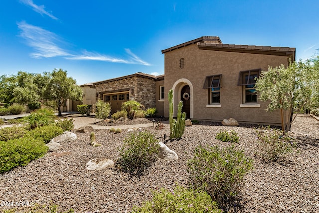 mediterranean / spanish house featuring a garage