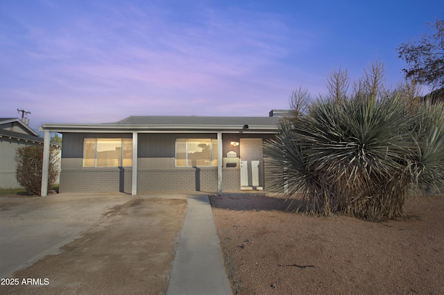 7520 E Papago Dr, Scottsdale, AZ 85257 - view of front of house featuring brick siding, a shingled roof, and covered porch