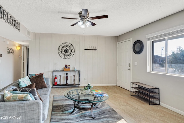 7520 E Papago Dr, Scottsdale, AZ 85257 - living room featuring baseboards, a textured ceiling, ceiling fan, and visible vents